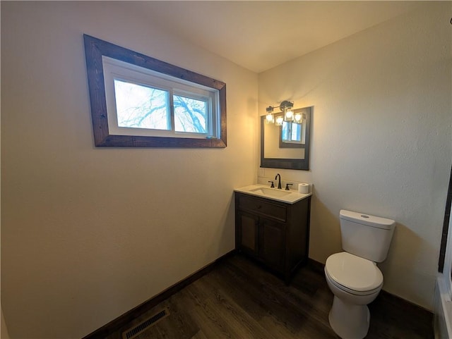 bathroom featuring vanity, toilet, and wood-type flooring