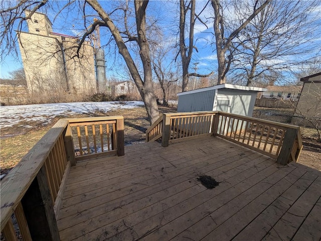 snow covered deck with a storage shed