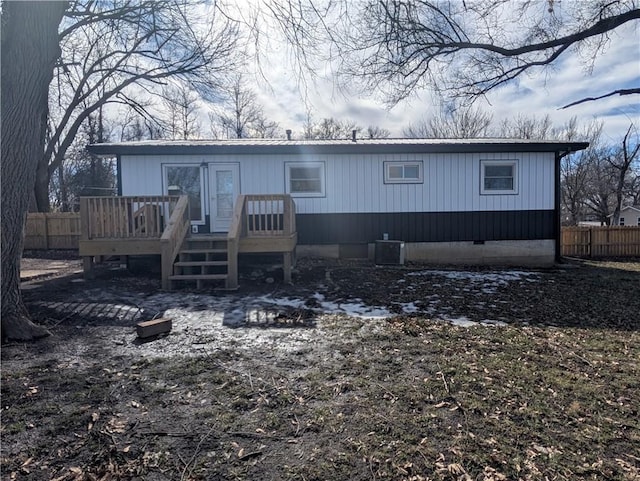 view of front of property featuring a wooden deck and central AC unit