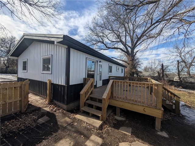 rear view of house featuring a wooden deck