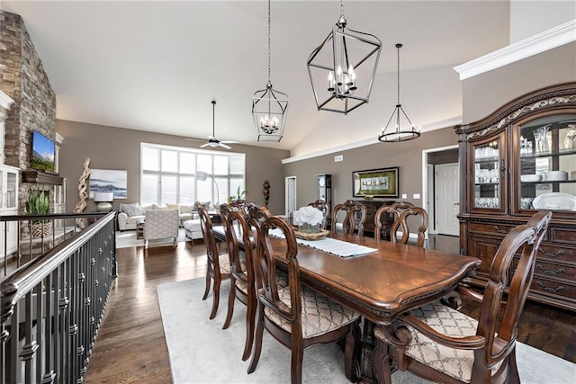 dining area with dark wood-type flooring, ceiling fan, and high vaulted ceiling