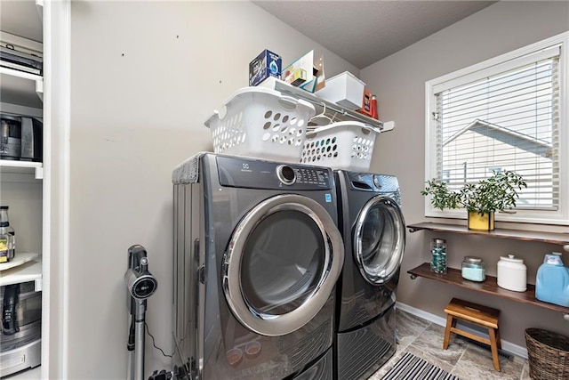 washroom featuring washing machine and clothes dryer