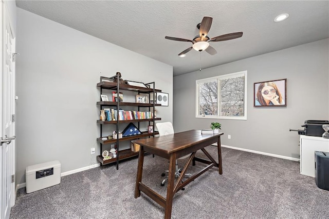 carpeted office space with ceiling fan and a textured ceiling