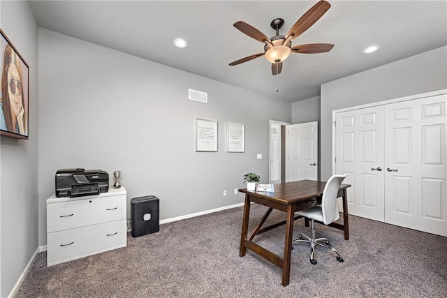 office area with ceiling fan and dark carpet