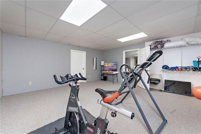 workout room featuring carpet flooring and a drop ceiling