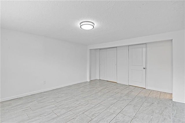 unfurnished bedroom featuring a closet and a textured ceiling