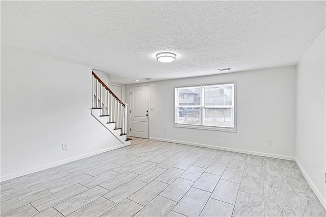 empty room featuring a textured ceiling