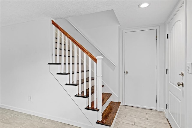 foyer entrance featuring a textured ceiling