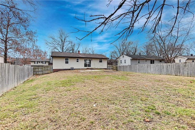 rear view of house with a yard