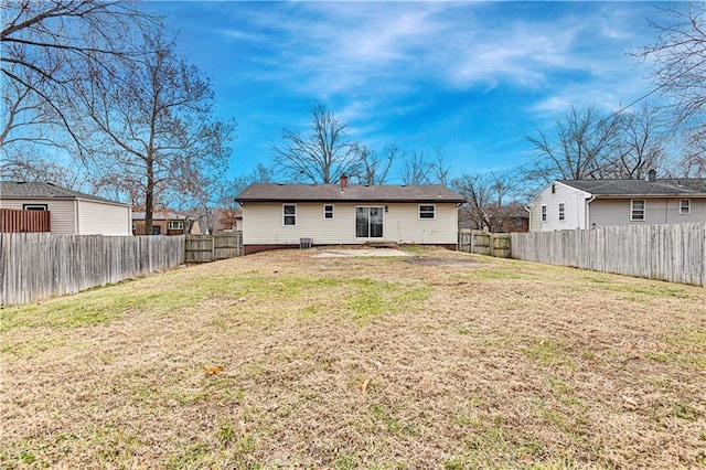 rear view of house featuring a yard