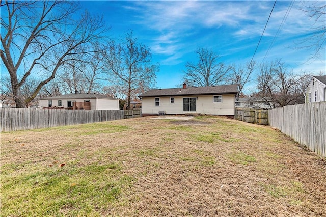 rear view of property with a lawn