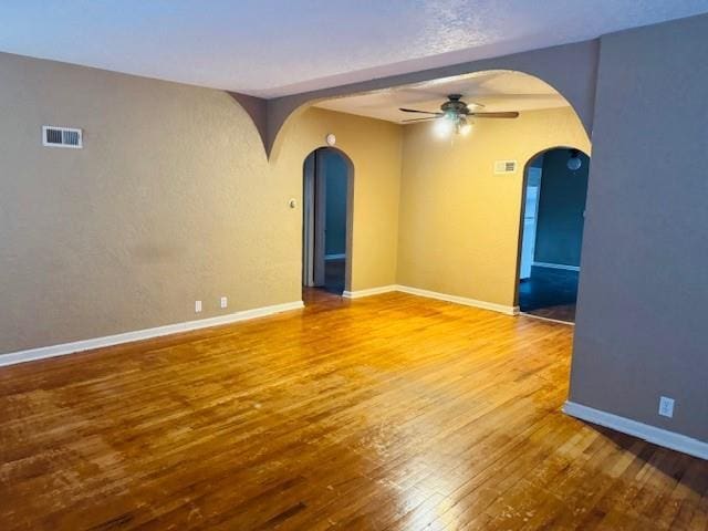 unfurnished room featuring hardwood / wood-style floors and ceiling fan