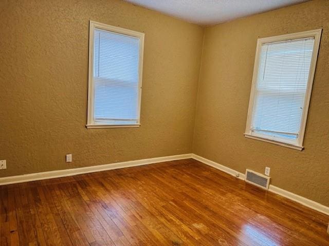 empty room with hardwood / wood-style flooring