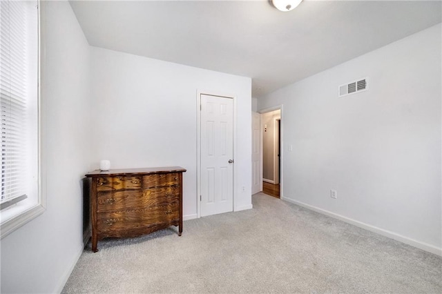 bedroom with light colored carpet