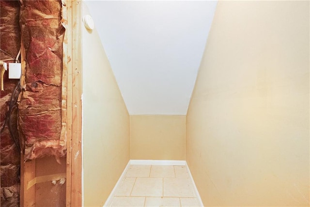 interior space featuring lofted ceiling and light tile patterned floors