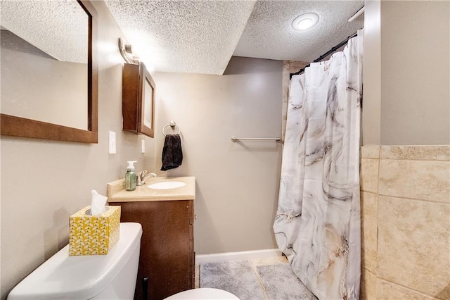 bathroom featuring vanity, a shower with shower curtain, a textured ceiling, and toilet