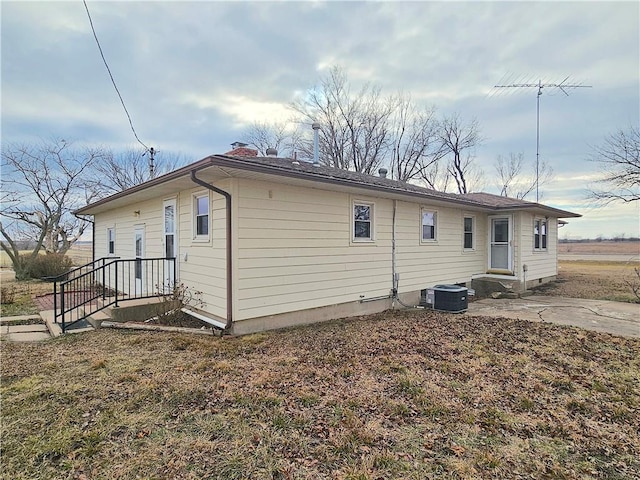 rear view of property with central AC unit