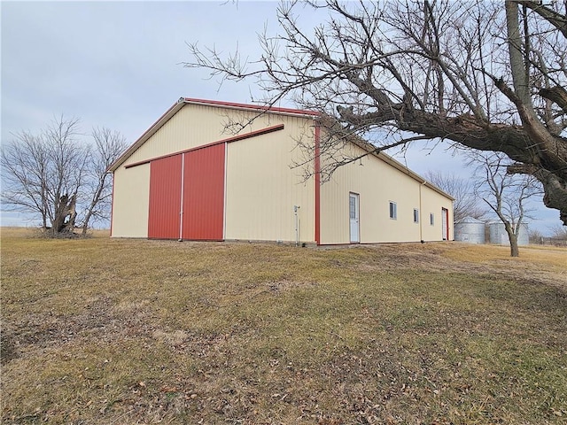 view of pole building with a yard