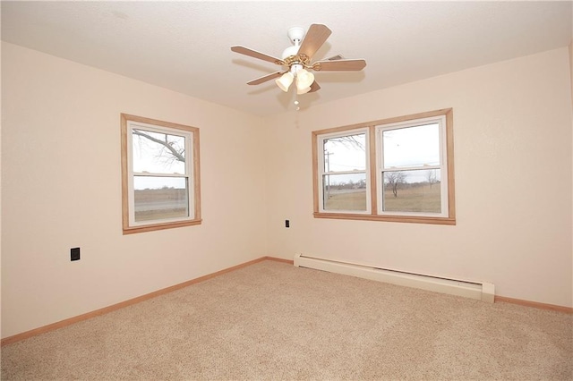 spare room with carpet floors, baseboards, a baseboard heating unit, and ceiling fan