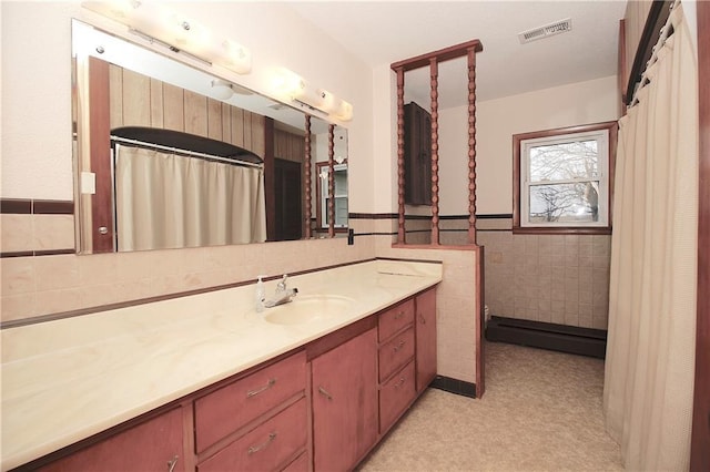 full bathroom featuring a wainscoted wall, visible vents, tile walls, and vanity