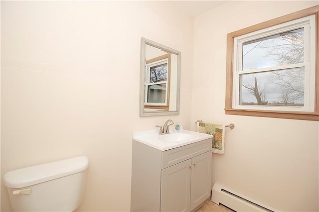 bathroom with baseboard heating, vanity, and toilet