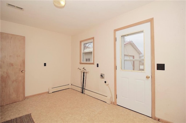 interior space with a baseboard heating unit and visible vents