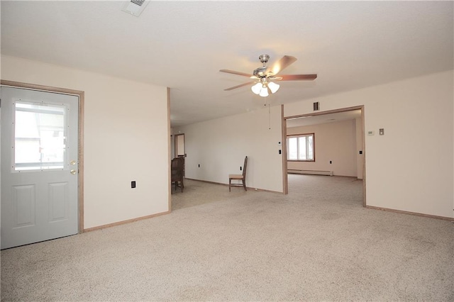 spare room featuring baseboards, a baseboard radiator, visible vents, and a ceiling fan