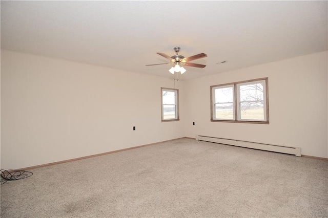 empty room with light carpet, a baseboard radiator, baseboards, and a ceiling fan