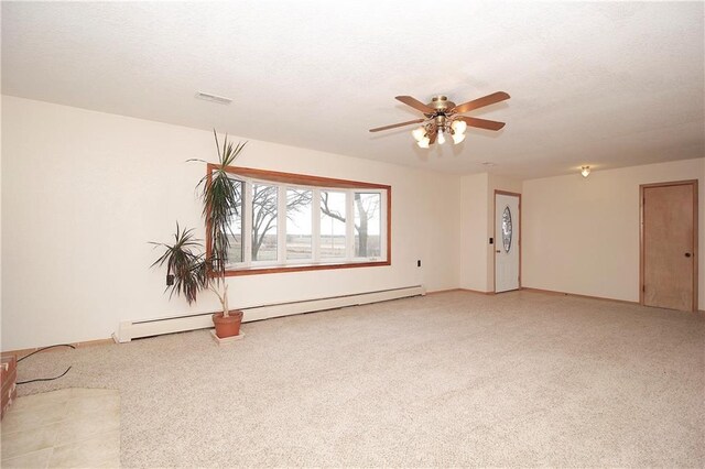 spare room with ceiling fan, visible vents, baseboard heating, and a textured ceiling