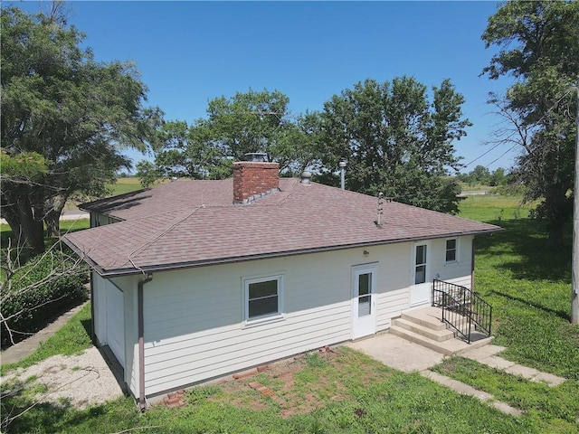 16702 S 59th Hwy, Welda, KS 66091 - rear view of house with a chimney, roof with shingles, and a lawn