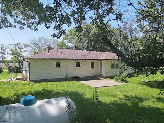 16702 S 59th Hwy, Welda, KS 66091 - back of property with a patio area, a chimney, and a lawn