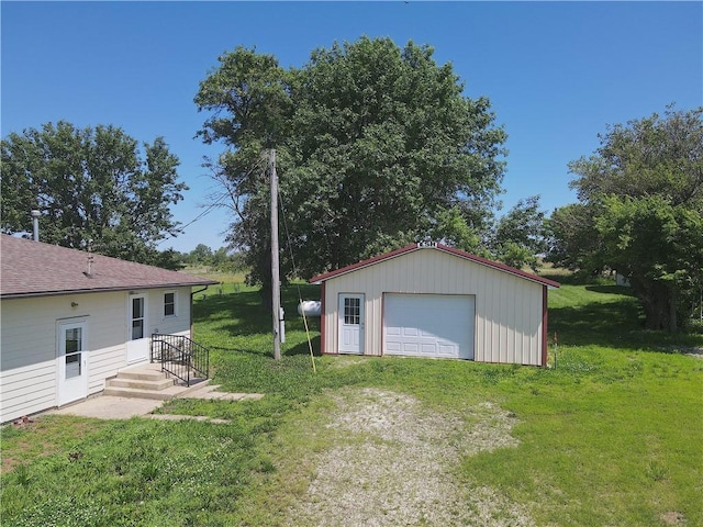 16702 S 59th Hwy, Welda, KS 66091 - view of grassy yard featuring a detached garage, an outbuilding, and driveway