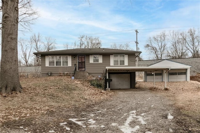 view of front of home with a garage and a carport