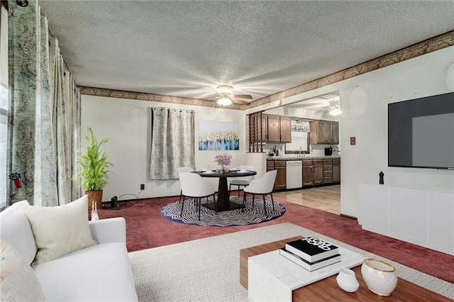 living room featuring ceiling fan and a textured ceiling