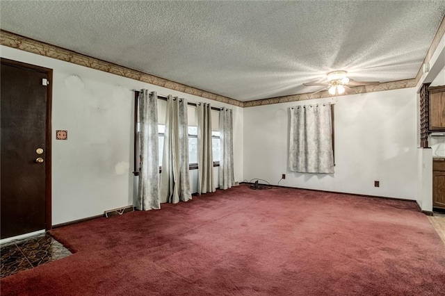 carpeted empty room with a textured ceiling, visible vents, and baseboards