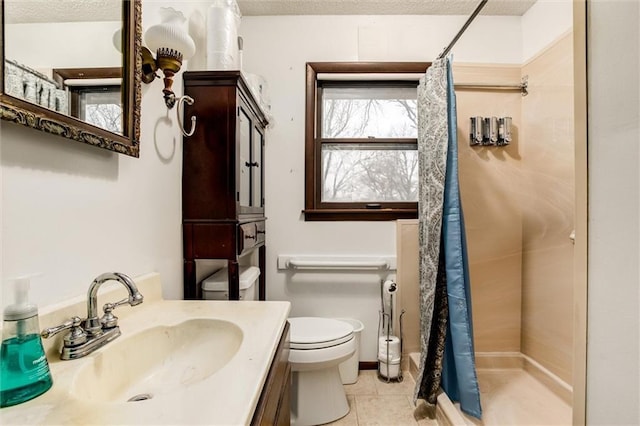 bathroom with a textured ceiling, tile patterned flooring, toilet, and a shower with curtain