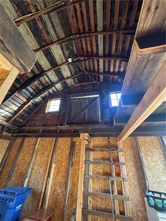 stairs featuring vaulted ceiling