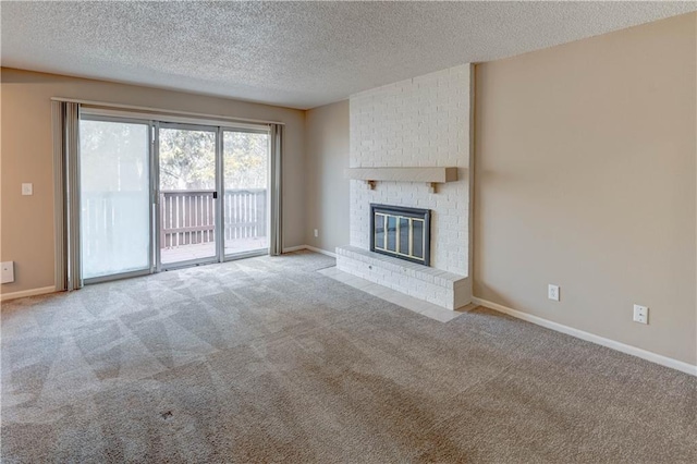 unfurnished living room featuring light colored carpet, a textured ceiling, and a fireplace