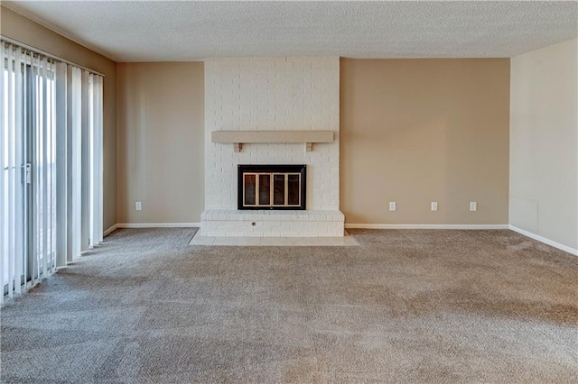 unfurnished living room featuring light colored carpet, a brick fireplace, and a textured ceiling