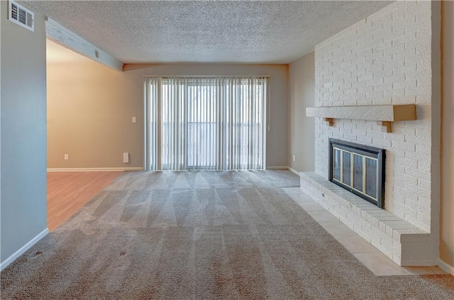 unfurnished living room featuring light colored carpet, a fireplace, and a textured ceiling