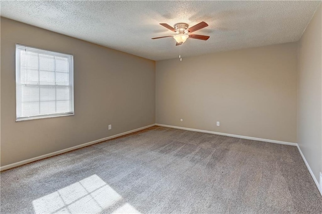 carpeted empty room with a textured ceiling and ceiling fan