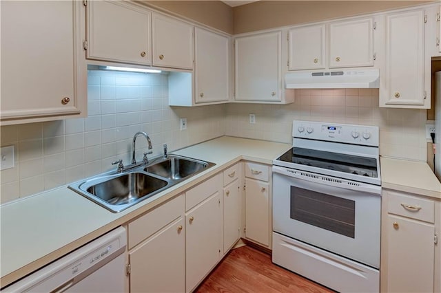 kitchen with sink, white cabinets, white appliances, light hardwood / wood-style floors, and backsplash