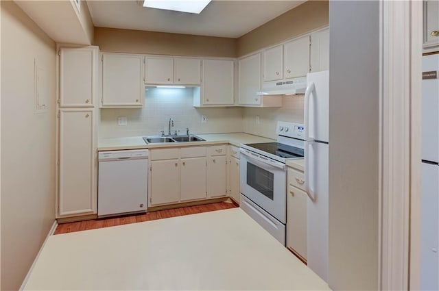 kitchen featuring sink, white cabinetry, light wood-type flooring, white appliances, and backsplash