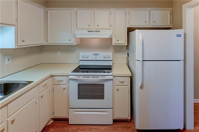 kitchen with light hardwood / wood-style flooring, white cabinets, white appliances, and decorative backsplash