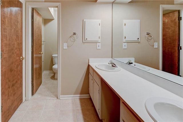 bathroom with vanity, tile patterned floors, and toilet