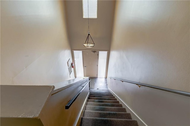 staircase featuring a towering ceiling