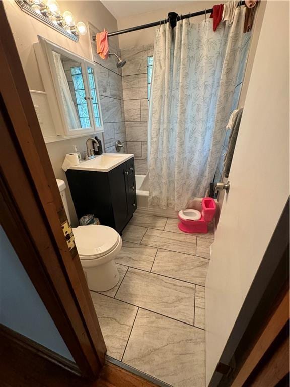 full bathroom with vanity, shower / tub combo, and toilet