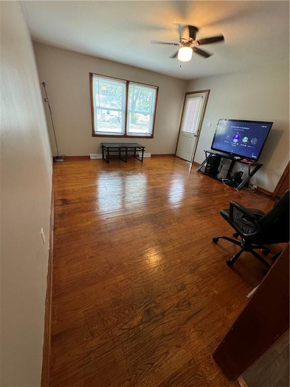 unfurnished living room featuring hardwood / wood-style flooring and ceiling fan