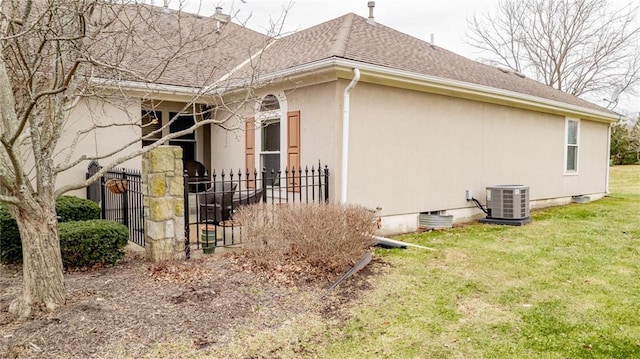 view of side of property featuring a yard and cooling unit