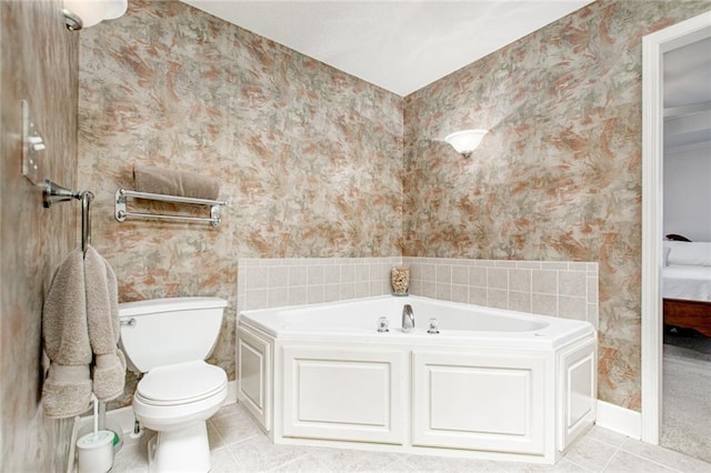 bathroom featuring tile patterned floors, toilet, and a bathtub